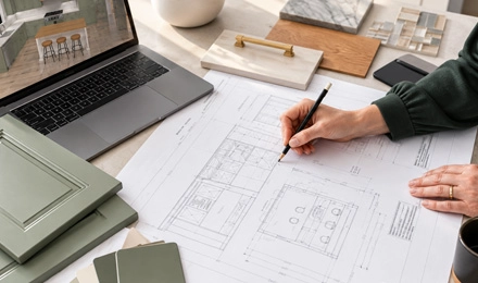 Kitchen designer reviewing a cabinet layout and itemized quote with a client.