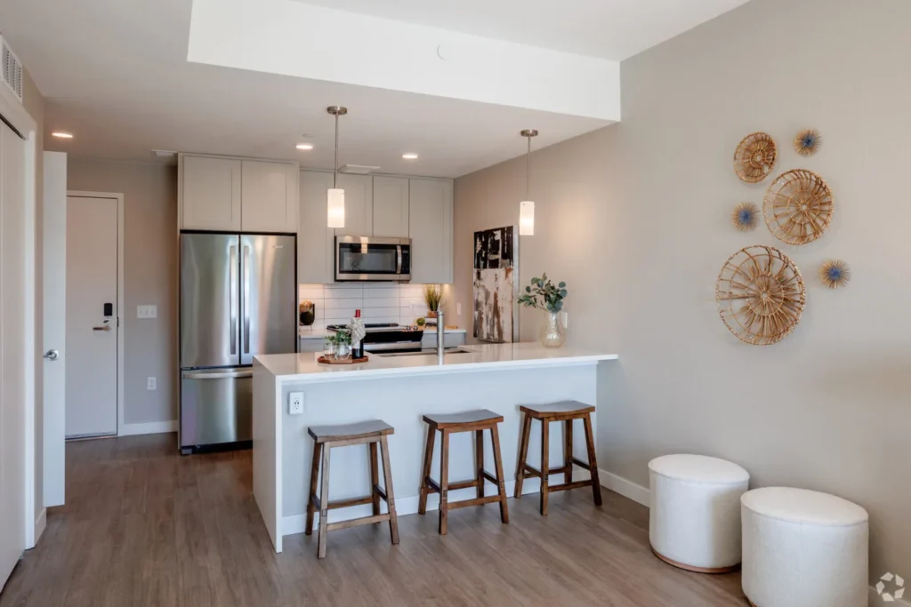 Everlyn White Shaker one-wall kitchen with white quartz peninsula and three stools in Denver, Colorado