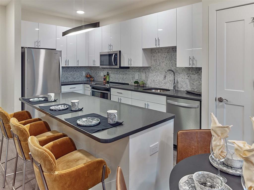 Glossy white slab kitchen with peninsula seating in Union, New Jersey